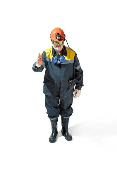 The studio shot of senior bearded male miner standing at the camera on a white background. — Stock Photo, Image