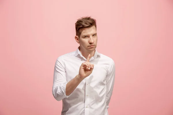 The young man whispering a secret behind her hand over pink background — Stock Photo, Image