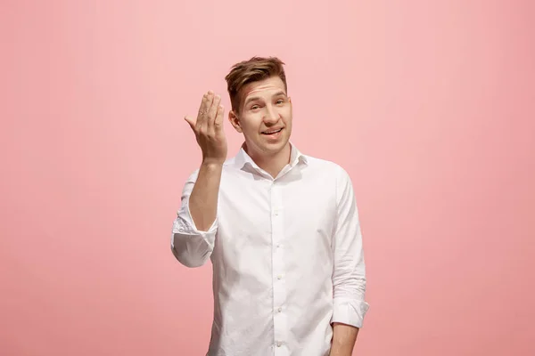 Isolated on pink young casual man shouting at studio — Stock Photo, Image