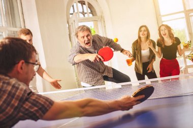 Ping pong Masa Tenisi oynarken mutlu genç arkadaş grubu