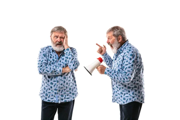 Senior man arguing with himself on white studio background. — Stock Photo, Image