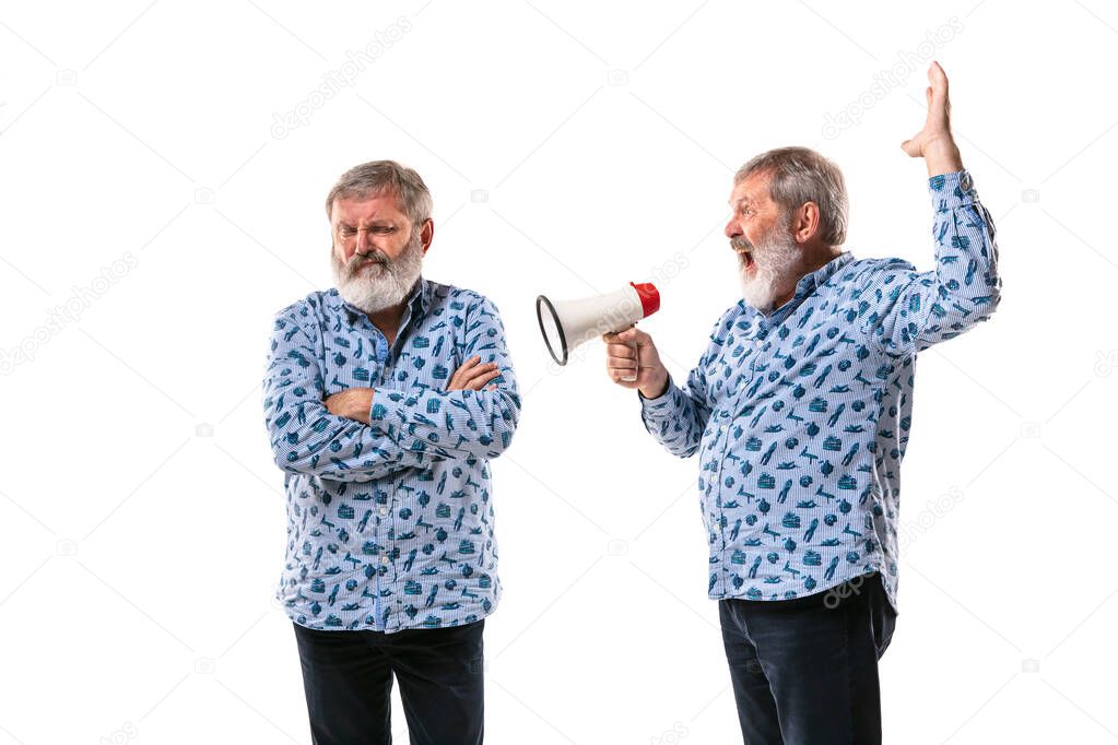 Senior man arguing with himself on white studio background.