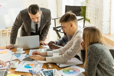 Bir grup genç iş adamı toplantı yapıyor, yaratıcı bir ofis.