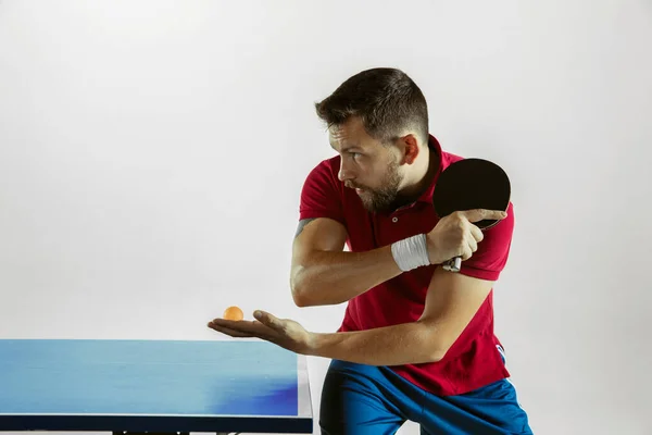 Joven jugando al tenis de mesa sobre fondo blanco del estudio —  Fotos de Stock