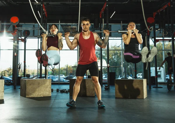 Un grupo de atletas musculares haciendo ejercicio en el gimnasio — Foto de Stock