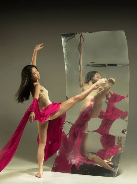 Jovem e elegante moderno bailarino de balé no fundo marrom — Fotografia de Stock
