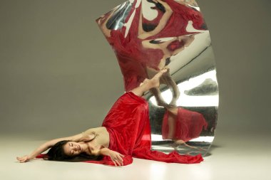 Kahverengi arka planda genç ve şık modern bale dansçısı