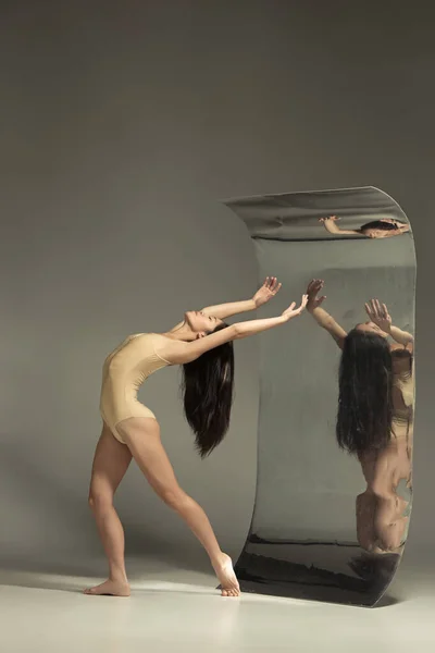 Молодой и стильный современный артист балета на коричневом фоне — стоковое фото