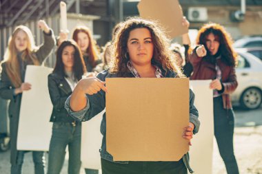 Young people protesting of women rights and equality on the street clipart