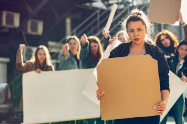 Young people protesting of women rights and equality on the street clipart