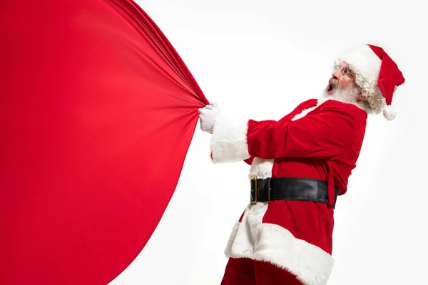 Père Noël tirant énorme sac plein de cadeaux de Noël isolé sur fond blanc — Photo
