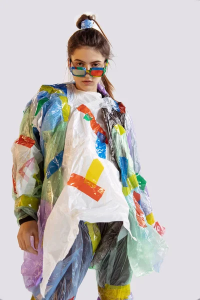Woman addicted of sales and clothes, wearing plastic, recycling concept — ストック写真