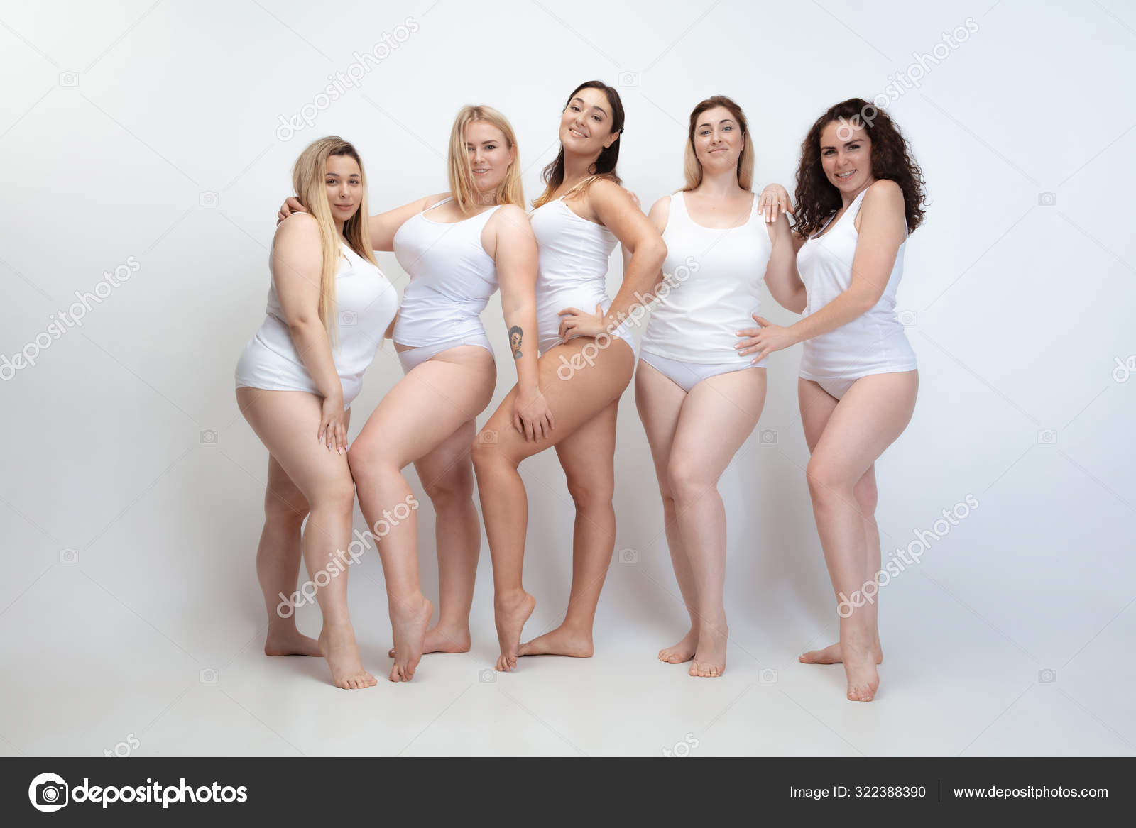 Portrait of beautiful plus size young women posing on white