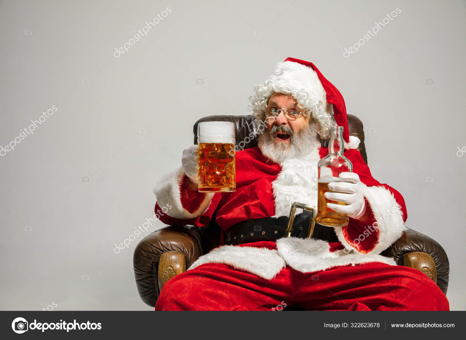 Santa Claus drinking beer sitting on armchair, congratulating of New Year  2020 Stock Photo by ©vova130555@gmail.com 322623678
