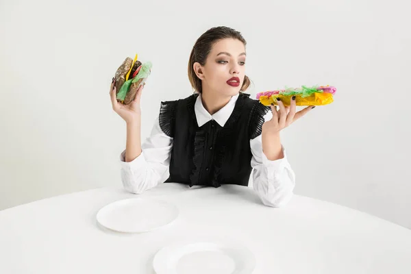 We are what we eat. Womans eating plastic food, eco concept