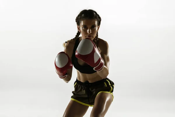 Fit caucasian woman in sportswear boxing isolated on white studio background — Stock Photo, Image