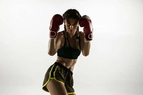 Fit caucasian woman in sportswear boxing isolated on white studio background — Stock Photo, Image