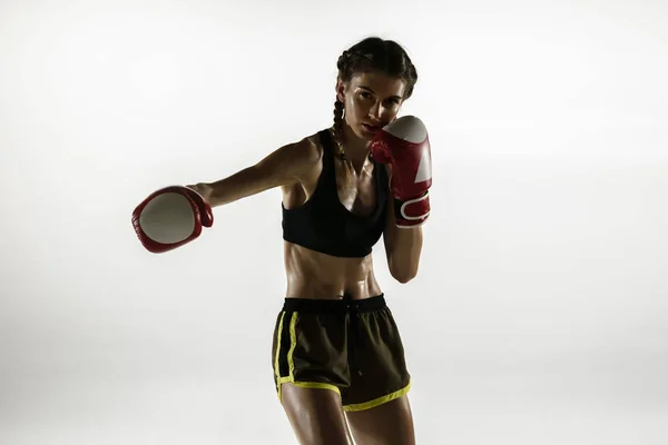 Fit caucasian woman in sportswear boxing isolated on white studio background — ストック写真
