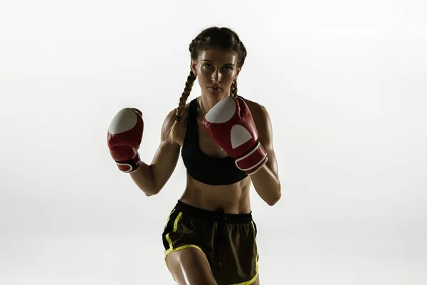 Fit caucasian woman in sportswear boxing isolated on white studio background — Stock Photo, Image