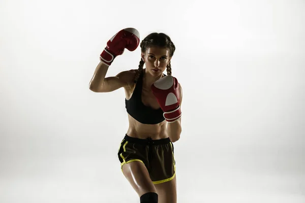 Fit caucasian woman in sportswear boxing isolated on white studio background — Stock Photo, Image