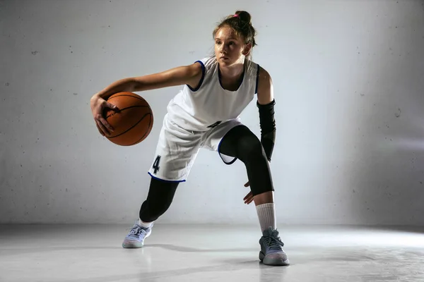 Jonge blanke vrouwelijke basketbalspeler tegen witte muur achtergrond — Stockfoto