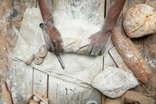 Vista superior do homem afro-americano cozinha pão na cozinha artesanal — Fotografia de Stock