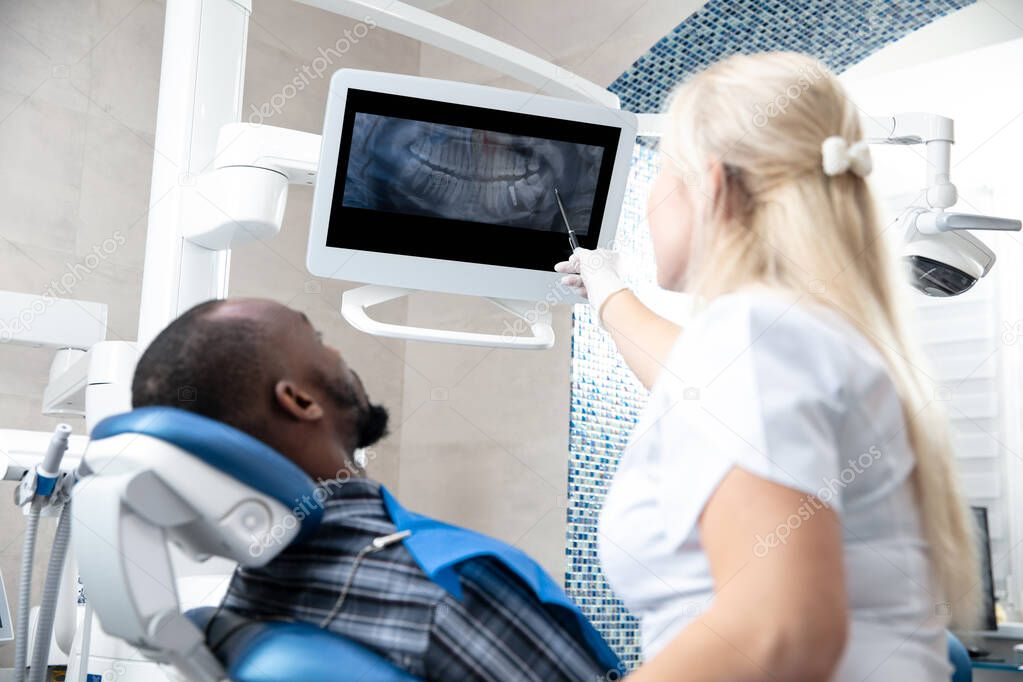 Young african-american man visiting dentists office