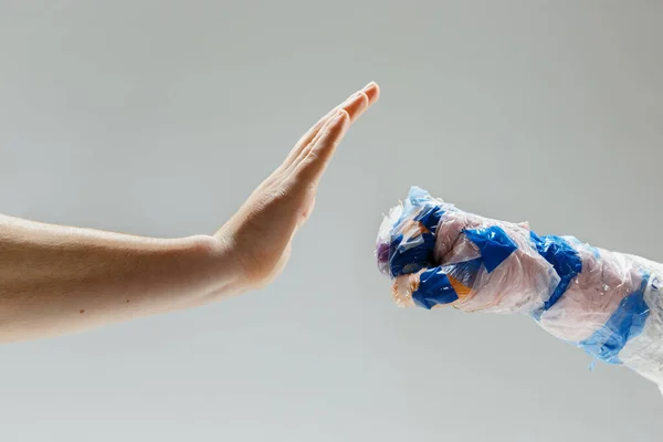 Stor plast hand gjord av skräp med en annan isolerad på vit studio bakgrund — Stockfoto