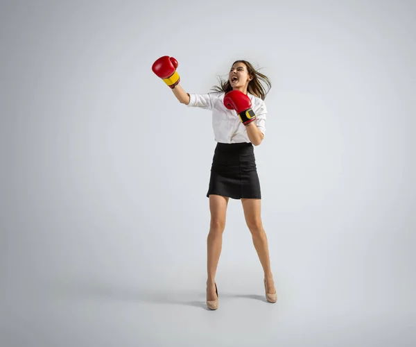 Mujer caucásica en ropa de oficina boxeo aislado en fondo gris estudio — Foto de Stock