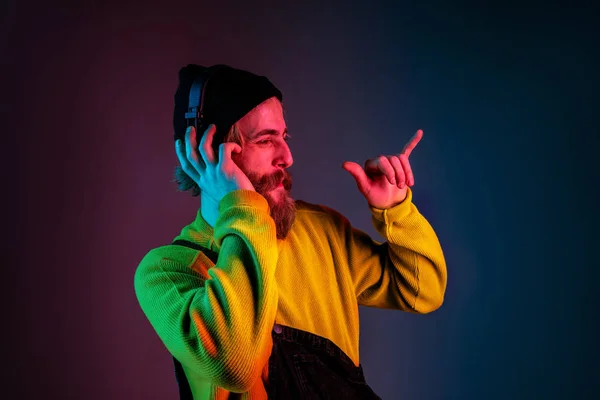 Potret laki-laki kaukasia terisolasi pada latar belakang studio gradien dalam cahaya neon — Stok Foto