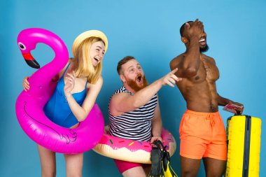 Mutlu genç arkadaşlar mavi stüdyoda dinleniyor.