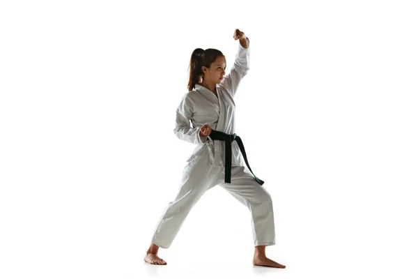 Confident junior in kimono practicing hand-to-hand combat, martial arts — Stock Photo, Image