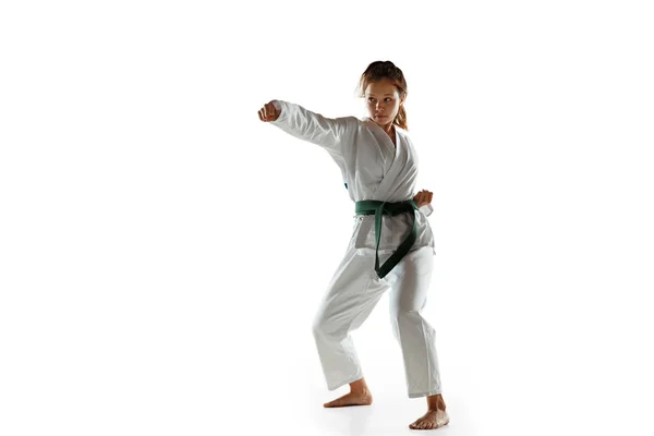 Confident junior in kimono practicing hand-to-hand combat, martial arts — Stock Photo, Image