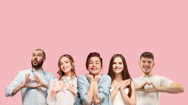Retrato de grupo multiétnico de jovens isolados no fundo do estúdio rosa, panfleto, colagem — Fotografia de Stock
