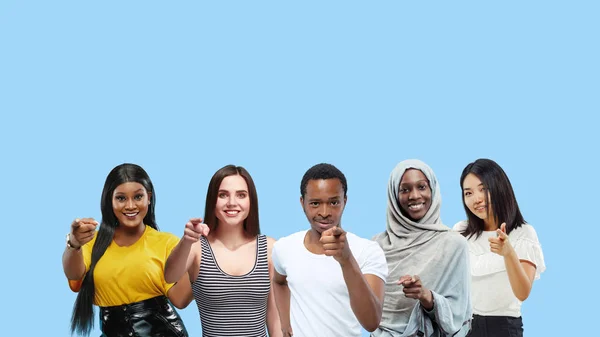 Portrait of multiethnic group of young people isolated on blue studio background, flyer, collage — Stock Photo, Image