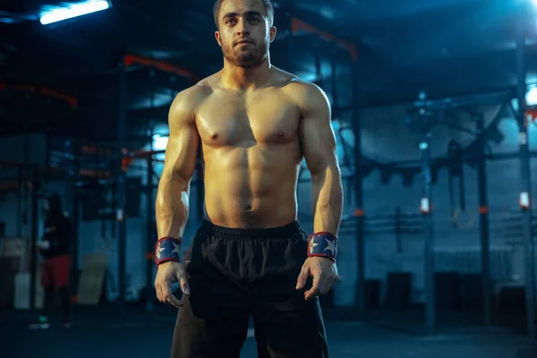 Caucasian man practicing in weightlifting in gym