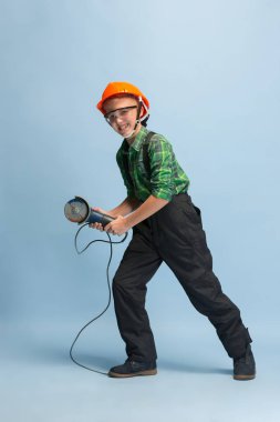 Boy dreaming about future profession of engineer