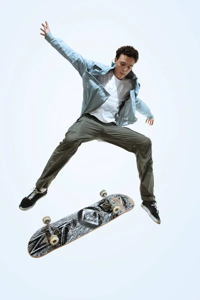 Caucasian young skateboarder riding isolated on a white background — Stock Photo, Image