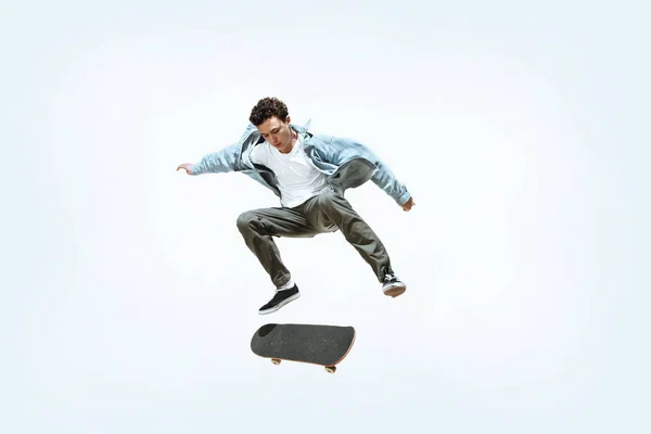 Caucasian young skateboarder riding isolated on a white background — 스톡 사진