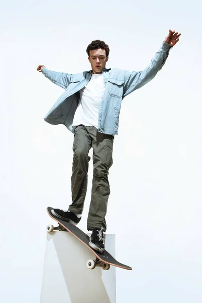 Caucasian young skateboarder riding isolated on a white background — Stock Photo, Image