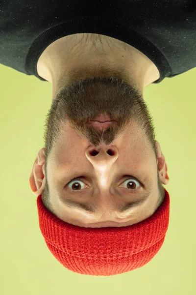Inverted portrait of caucasian young man on yellow studio background — 스톡 사진