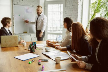 Bir grup genç iş adamı toplantı yapıyor, yaratıcı bir ofis.