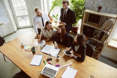 Bir grup genç iş adamı toplantı yapıyor, yaratıcı bir ofis.