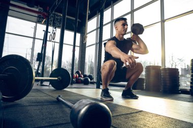 Erkek sporcu spor salonunda sıkı antrenman yapıyor. Fitness ve sağlıklı yaşam konsepti.
