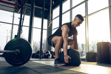 Erkek sporcu spor salonunda sıkı antrenman yapıyor. Fitness ve sağlıklı yaşam konsepti.