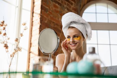 Beauty Day. Woman doing her daily skincare routine at home clipart