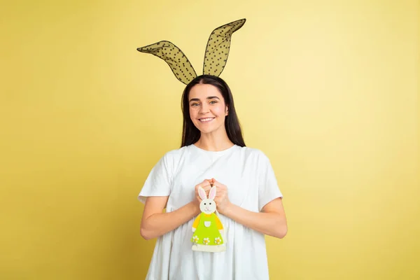Easter bunny woman with bright emotions on yellow studio background — Stock Photo, Image