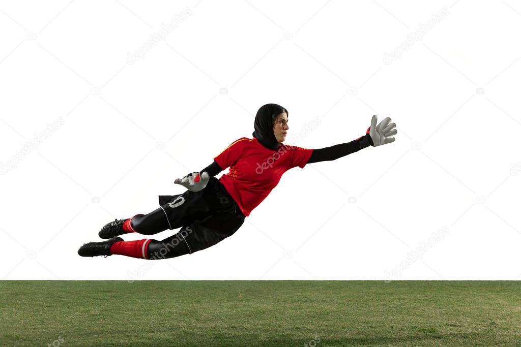 Arabian female soccer or football player, goalkeeper on white studio background