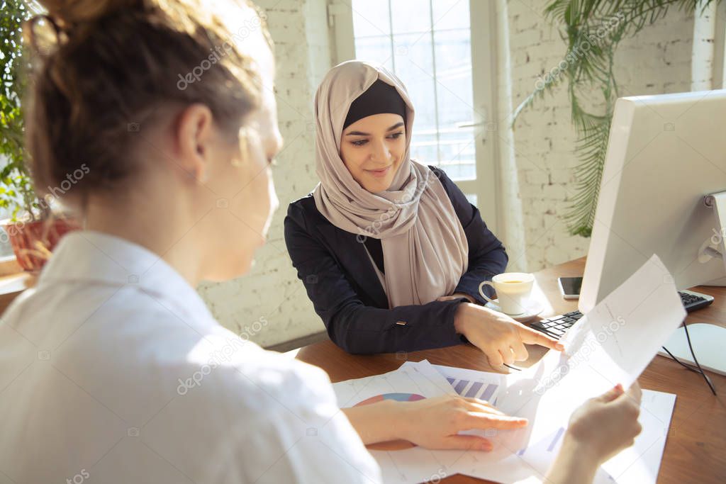 Portrait of a beautiful arabian businesswoman wearing hijab while working