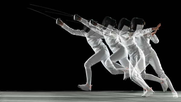 Teen girl in fencing costume with sword in hand isolated on black background — 스톡 사진
